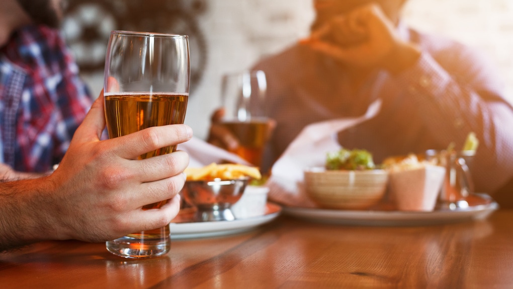 Male Hand Holding Beer Glass in one of the restaurants in sudbury